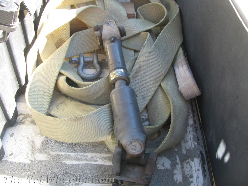 Drive shaft with U-joints and straps in a cargo area