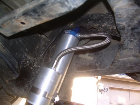 1993 Toyota 4Runner - An aftermarket shock absorber with a remote reservoir is visible, attached to the vehicle's frame.