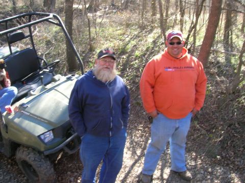 1996 Ford Bronco - Two men stand in a wooded area next to an olive green ATV.