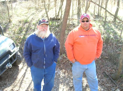 1996 Ford Bronco - Two men stand in a wooded area with an ATV to their left.