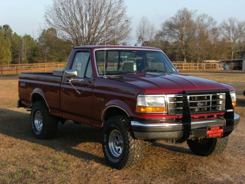 1992 Ford F-150 - This Ford F-150 pickup truck is shown in a three-quarter front view, parked outdoors on a grassy area.