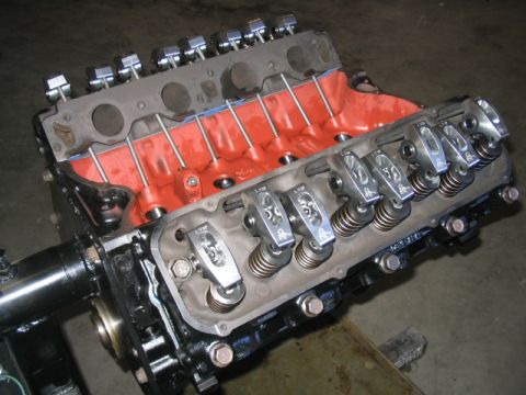 1979 Ford F-150 - This image shows a V8 engine block with visible valve train components and an orange intake manifold.