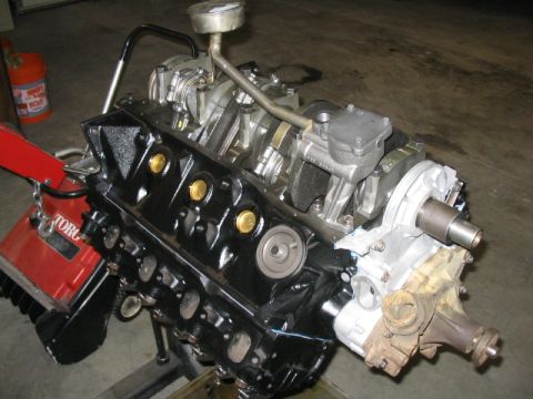 1979 Ford F-150 - A V8 engine, likely from a truck, is mounted on an engine stand for repair or rebuilding.