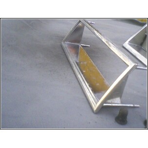 1972 Ford Ranchero - Close-up of two chrome trim pieces with yellow inserts, likely automotive parts.