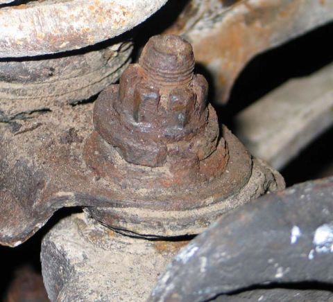 1994 Ford Bronco - This close-up shows a corroded ball joint nut, indicating significant wear on this vehicle's suspension part.