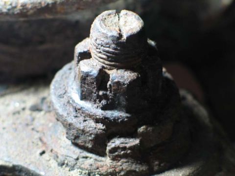 1994 Ford Bronco - A heavily corroded bolt and nut assembly is shown in close-up detail.