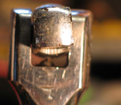 1994 Ford Bronco - A close-up view of a metal ratchet tool head shows signs of wear and use.