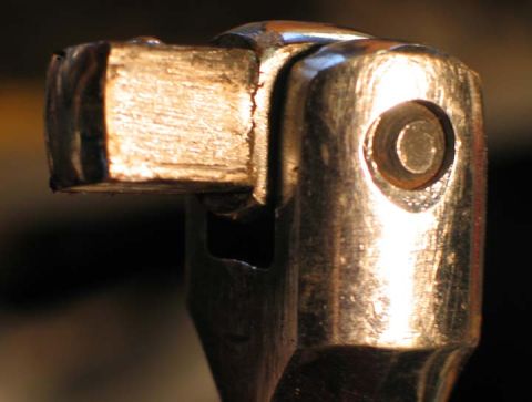 1994 Ford Bronco - A close-up view shows a socket wrench engaging with a bolt, highlighting mechanical detail.