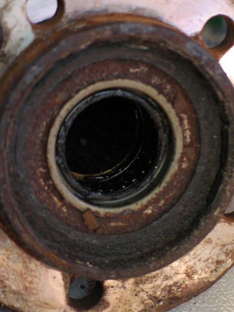 1994 Ford Bronco - This is a close-up view of a rusted wheel hub assembly, likely needing replacement.