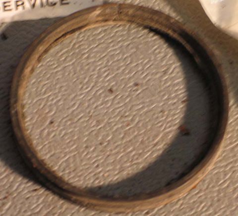1994 Ford Bronco - A close-up of a worn metal ring, possibly a gasket or bearing, with partial text visible.