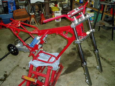 2000 Ford E350 - Motorcycle frame and front suspension assembly in a workshop setting.