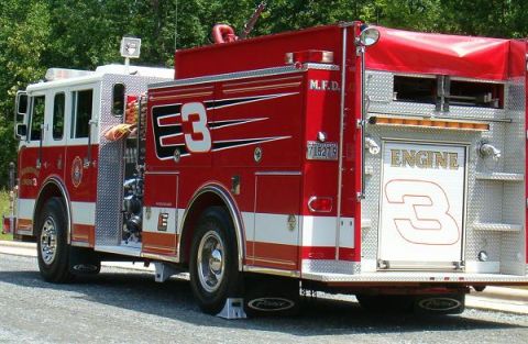 1998 Ford Crown Victoria - A red and white fire engine with the number 3 prominently displayed is parked outdoors.