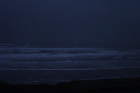 1993 Ford Bronco - The image shows waves crashing on a beach during twilight, with a website address visible in the corner.