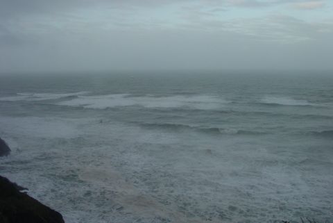 1993 Ford Bronco - The ocean churns with waves under an overcast sky, viewed from a cliffside.