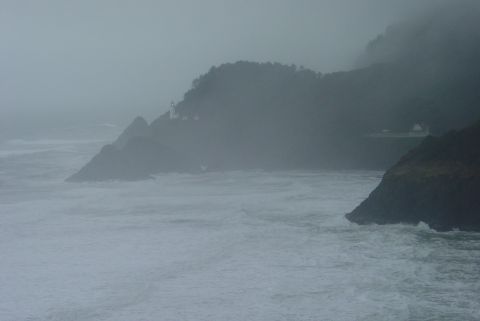 1993 Ford Bronco - Coastal scene with rough seas and a lighthouse on a foggy day.