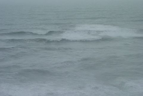 1993 Ford Bronco - Ocean waves crash under a hazy sky, with the Supermotors logo visible in the lower right corner.