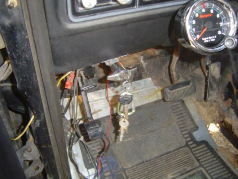 1979 Ford Bronco - Interior view of a 1979 Ford Bronco, highlighting the floor pedals and an aftermarket tachometer.