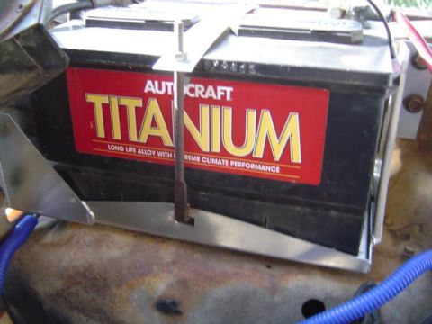 1979 Ford Bronco - A close-up view of a car battery with a red and yellow label.