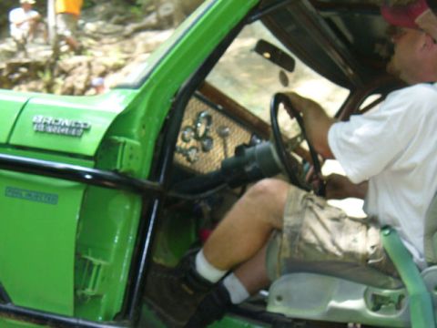 1978 Ford Bronco - Driver's perspective inside a green 1978 Ford Bronco, showing the dashboard and steering wheel.
