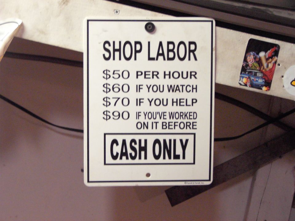 Shop labor sign with rates for watching, helping, or prior work