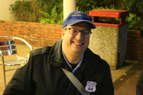 1991 Ford Crown Victoria - Man wearing a blue cap and glasses smiles for the camera, with a brick wall and trash can in the background.