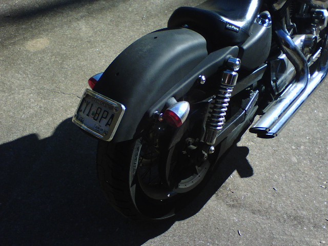 Motorcycle rear fender, taillights, license plate CY1-8PA, and chrome exhaust