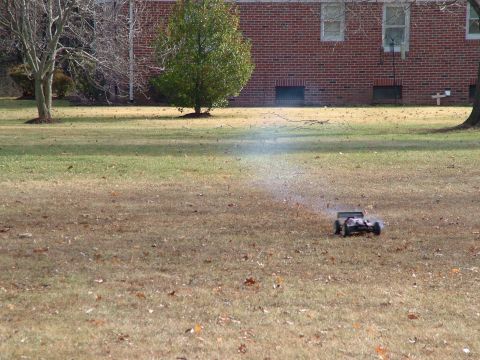 1994 Ford Bronco - A remote control car is driven across a grassy field, creating a dust cloud.