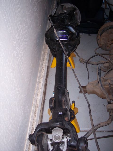1996 Ford Bronco - A front axle assembly, likely for a D60 swap, is shown supported by yellow jack stands.