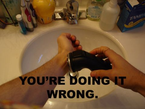 1992 Ford Mustang - A person is shown shaving their arm over a sink, with text that reads 'YOU'RE DOING IT WRONG.'