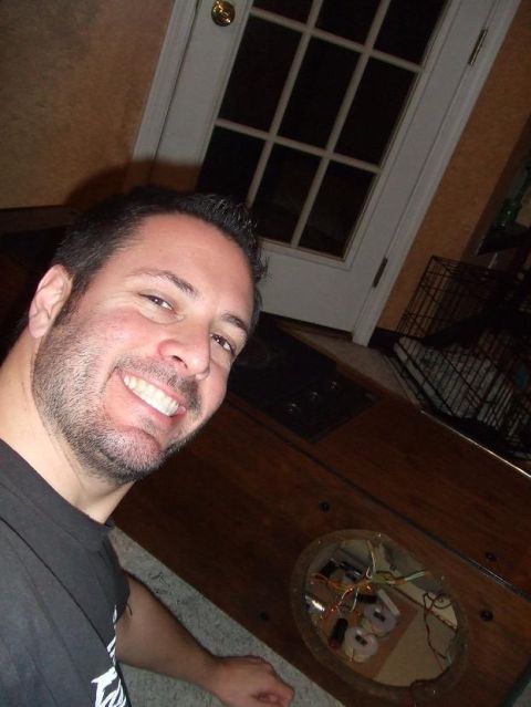 1987 Ford Bronco - A man smiles for a selfie in front of a door, with a dog crate visible in the background.