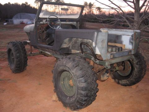 1980 Jeep CJ7 - This Jeep CJ-series is missing its hood and doors, and sits on large off-road tires.