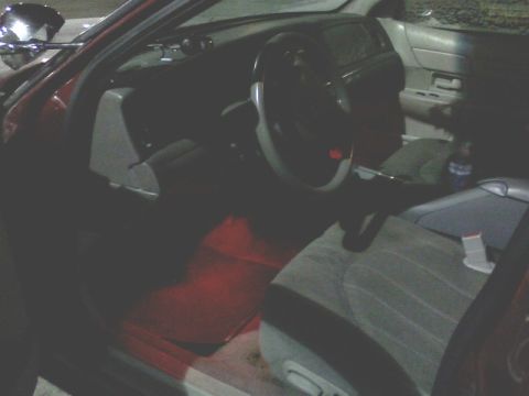 2001 Ford Crown Victoria - The interior of a 2001 Ford Crown Victoria is visible, the steering wheel, dashboard, and passenger seats.