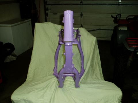 2000 Ford E350 - A purple motorcycle frame is displayed in a garage, with a freezer and an ATV visible in the background.