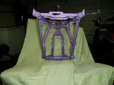 2000 Ford E350 - Motorcycle frame painted purple and displayed on a cloth.