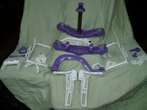 2000 Ford E350 - Several painted motorcycle components are arranged on a draped surface.
