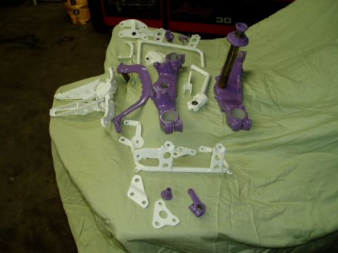 2000 Ford E350 - Several painted motorcycle components are arranged on a green cloth, possibly after a restoration or customization project.