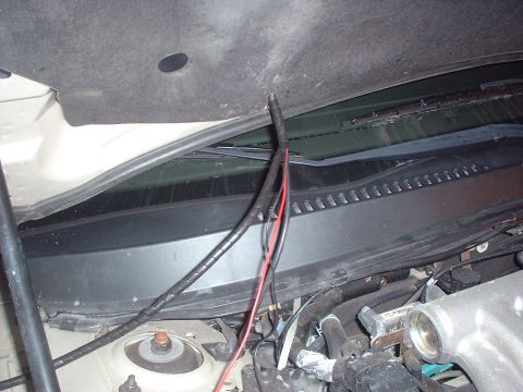 2000 Ford Taurus - Close-up view of exposed wiring in a vehicle's engine bay.