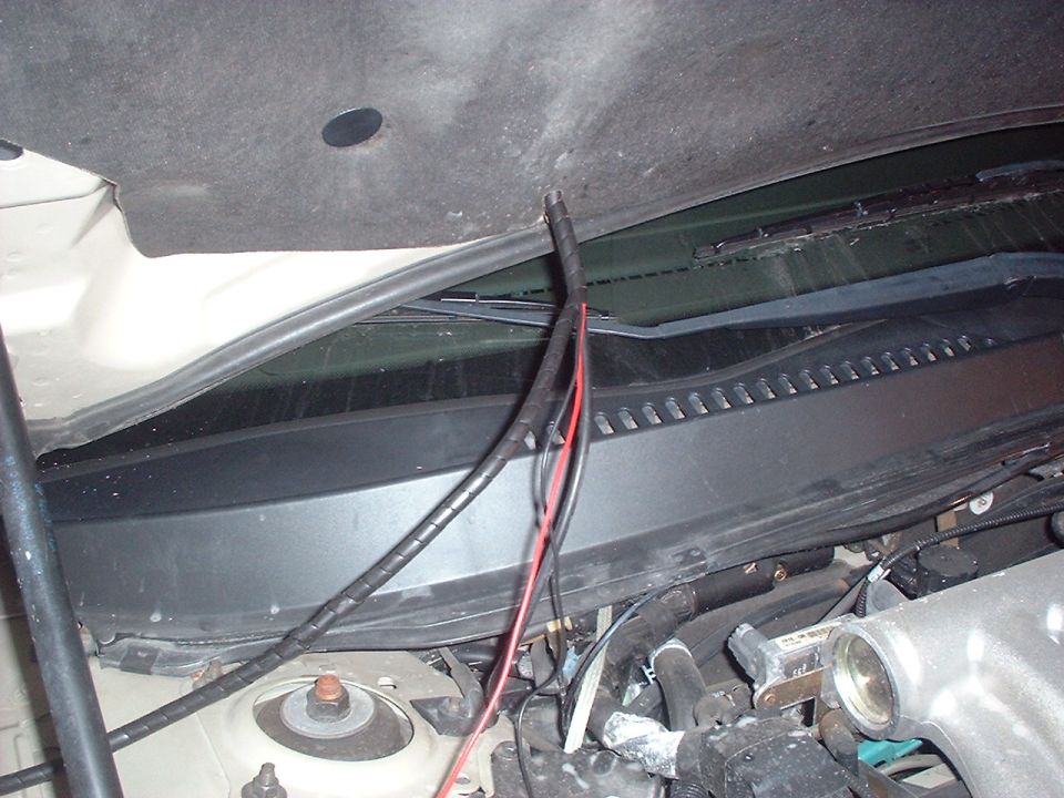Engine bay wiring with red and black wires exposed near the windshield cowl