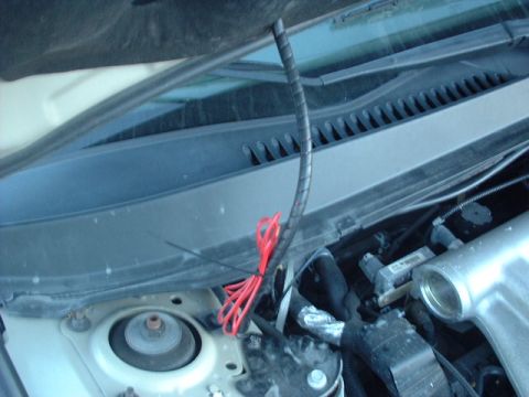 2000 Ford Taurus - A view into the engine compartment shows various wires and mechanical parts.