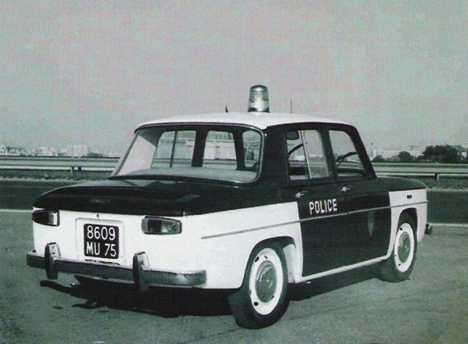 Two-tone police car with "POLICE" text on the side and a light bar on the roof