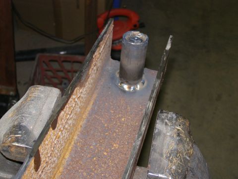 1993 Ford Bronco - A metal part, likely a component of a bumper or frame, is secured in a vise and shows signs of welding.