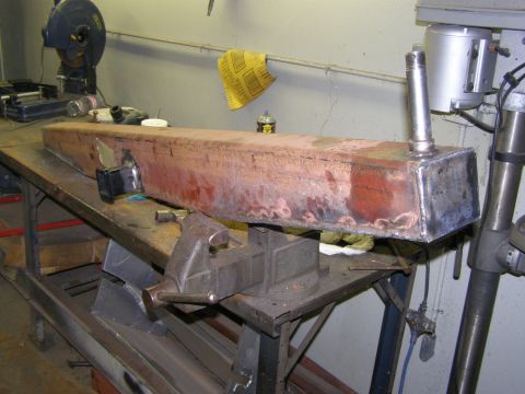 1993 Ford Bronco - Fabricated bumper part held in a vise on a workbench in a workshop setting.