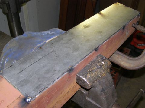 1993 Ford Bronco - A metal part is being welded and clamped in a vise, suggesting fabrication or repair work.