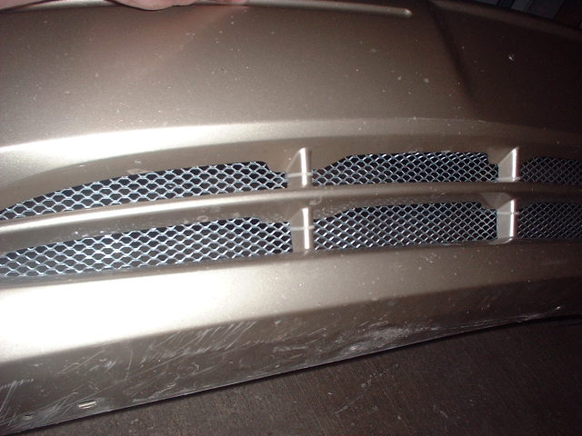 close-up of car's front grille with mesh inserts