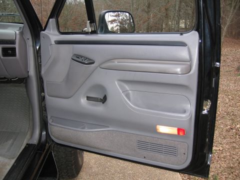 1967 Ford Mustang - Interior view of a truck's driver side door panel and armrest.