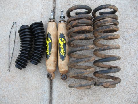 1995 Ford F-150 - Set of Superlift shocks and springs, likely for an off-road vehicle, laid out on a concrete surface.