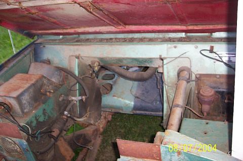 1978 Ford Bronco - The engine bay of a 1978 Ford Bronco shows its age with visible rust and wear.