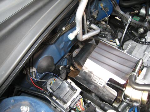2007 Subaru Impreza - Close-up view of engine bay components, including a COBB branded heat shield and various hoses and wiring.