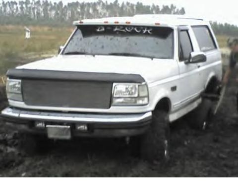 1995 Ford Bronco - This 1995 Ford Bronco is stuck in the mud, with custom text "D-ROCK" visible on the windshield.
