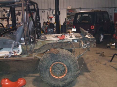 1995 Ford Bronco - A partially disassembled off-road vehicle sits in a garage, with another vehicle visible in the background.